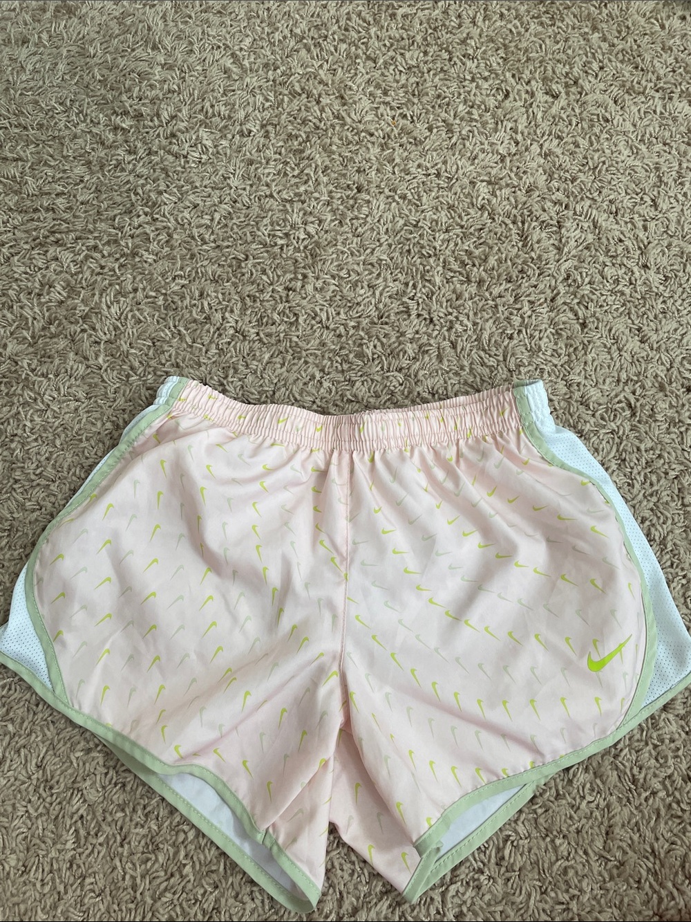 Nike Girls Light Pink Athletic Shorts with Neon Yellow Swoosh Pattern